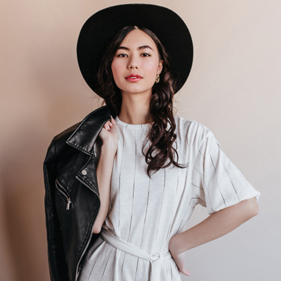 elegant asian woman white dress looking camera confident chinese woman hat holding leather jacket